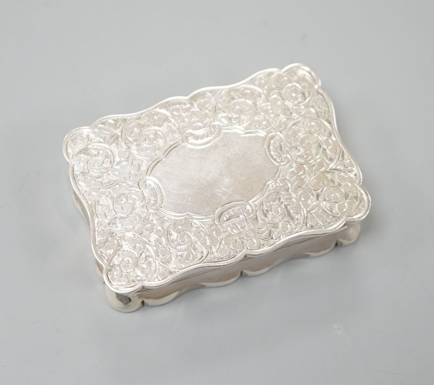 A late Victorian engrave silver vinaigrette by Saunders & Shepherd, Birmingham, 1896, 57mm.